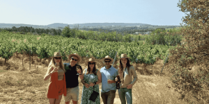 Group of friends enjoying a wine tour with Taca de Vi in a vineyard near Barcelona
