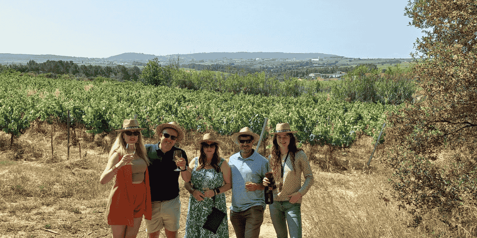 Group of friends enjoying a wine tour with Taca de Vi in a vineyard near Barcelona